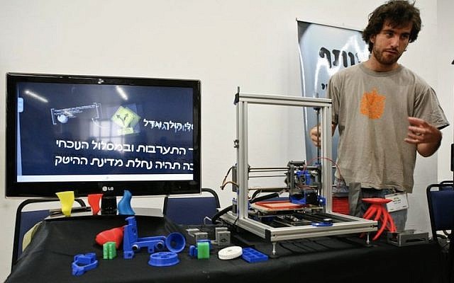 A member of the XLN staff shows off an open-source 3D printer (Photo credit: Courtesy)