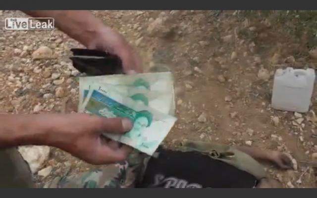 Iranian currency (photo credit: image capture from LiveLeaks video)