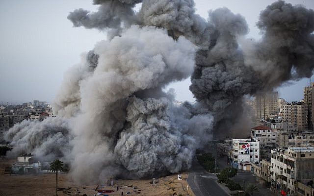 Smoke rises after an Israeli air force strike in Gaza City, Sunday, Nov. 18, 2012. (photo credit: AP/Bernat Armangue)