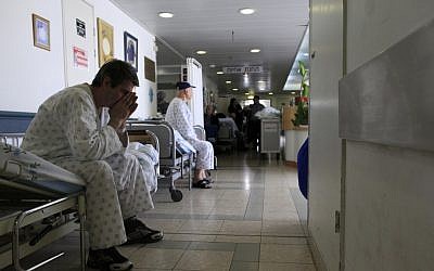 Patients wait in the hallway of the Barzilai Medical Center (photo credit: Tsafrir Abayov/Flash90)