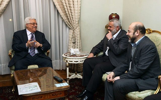 Palestinian President Mahmoud Abbas and Hamas Prime Minister Ismael Hanyah meet in Cairo, February 23, 2012 (photo credit: Mohammed Al-Hums/Flash90)