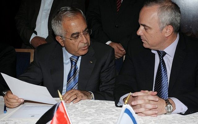 Finance Minister Yuval Steinitz (right) meets with PA Prime Minister Salam Fayyad as they sign an economic agreement in Jerusalem on July 31 (photo credit: Moshe Milner/GPO/Flash90)
