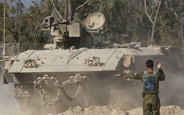 An Israeli soldier directs an APC after returning from an operation along the Israel-Gaza border (file photo: Tsafrir Abayov/Flash90)
