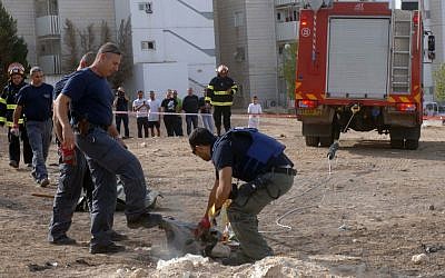 An explosive expert holds the remains of a rocket after it landed in Beersheba, November 16, 2012 (photo credit: Dudu Greenspan/Flash90)