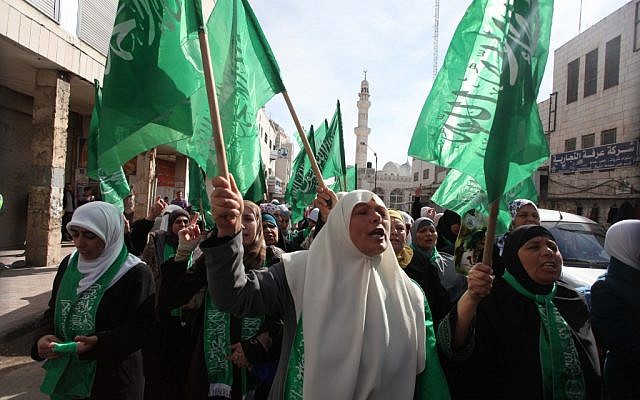 Palestinians wave Hamas flags during a demonstration in solidarity with Gaza and against Israel's military operation in the coastal enclave, in the WestBank city of Ramallah November 16, 2012 (photo credit: Issam Rimawi/Flash90)