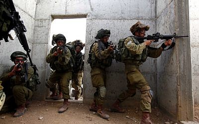 Soldiers take part in exercises simulating fighting in Gaza, at a military base in the Negev on November 17 (photo credit: Edi Israel/Flash90)