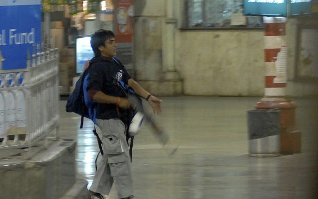 Mohammed Ajmal Kasab stalks a railway station in Mumbai during the 2008 terror attack. (Sebastian D'souza/Mumbai Mirror/File/AP)