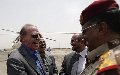 US Ambassador to Yemen Gerald M. Feierstein, left, shakes hands with a Yemeni army officer during a visit to Abyan, Yemen. Al-Qaida's branch in Yemen has offered to pay tens of thousands of dollars to anyone who kills Feierstein or an American soldier in the country, according to an audio produced by the group's media arm, the al-Malahem Foundation, and posted on militant websites Saturday, December 29, 2012. (photo credit: AP/Hani Mohammed, File)