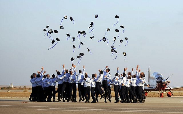 Israeli Air Force pilots throw their caps in the air during a graduation ceremony at the Hatzerim air force base, Thursday, June 30, 2011. (photo credit Michael Shvadron/IDF Spokesperson/Flash90)