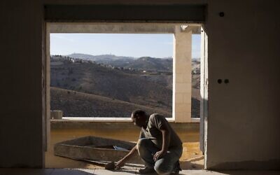 A Palestinian man working in construction in the settlement of Ma'aleh Adumim, near the E1 tract. (photo credit: Yonatan Sindel/Flash90)