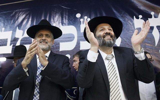 Ex-Shas member Eli Yishai (left) and Shas party chairman Aryeh Deri cheer during a party conference in Jerusalem, December 4, 2012. (photo credit: Yonatan Sindel/Flash90)