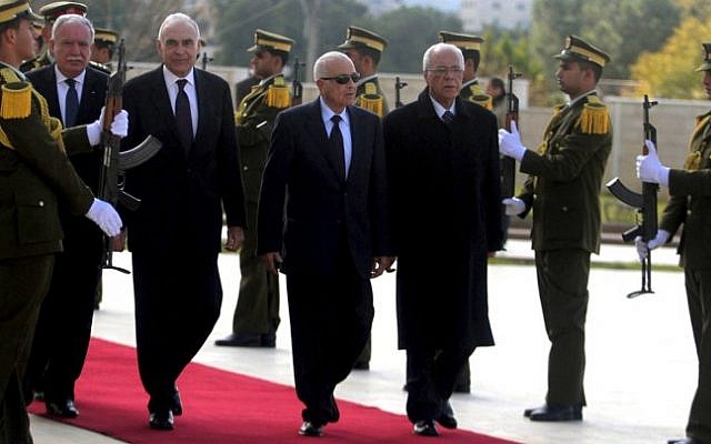 Arab League Secretary General Nabil Elaraby, second right, and Egyptian Foreign Minister Mohammed Kamel Amr, third right, walk past an honor guard upon their arrival in Ramallah Saturday (photo credit: Issam Rimawi/Flash90)