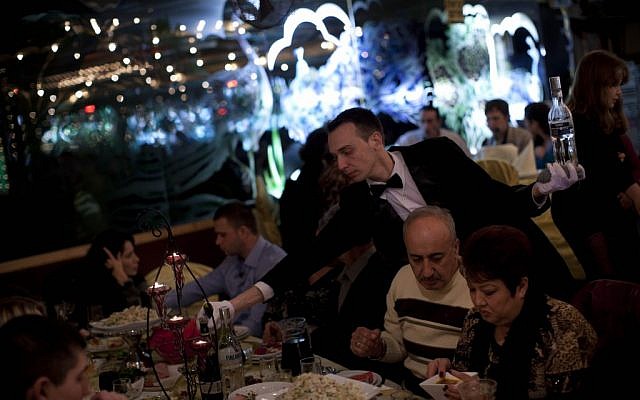 A waiter serves traditional Russian food at a seaside restaurant in Ashdod. (photo credit: AP Photo/Oded Balilty)