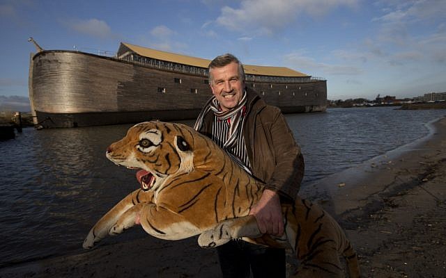 Johan Huibers poses with a stuffed tiger in front of the full scale replica of Noah’s Ark in Dordrecht, Netherlands, Monday, Dec. 10, 2012. (Peter Dejong/AP)