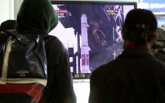 South Koreans watch a TV news program about North Korea's rocket launch plans at Seoul Railway Station in Seoul, South Korea on Sunday. (photo credit: AP/Ahn Young-joon)