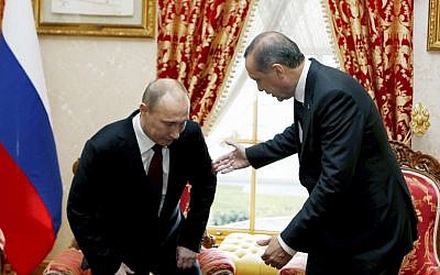 Russian President Vladimir Putin, left, sits down as Turkey's Prime Minister Recep Tayyip Erdogan looks on before a meeting in Istanbul, Turkey, Monday, Dec. 3, 2012. (photo credit: AP/Tolga Bozoglu, Pool)