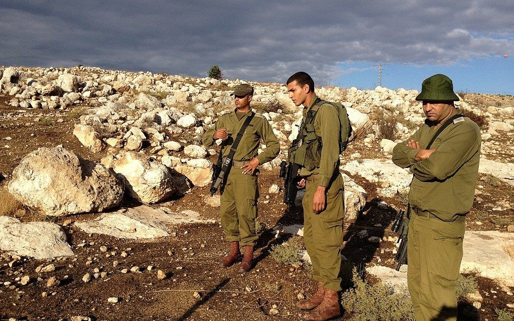 Lt. Col. Hassan, left, teaching a young tracker the ropes (Photo credit: Mitch Ginsburg/ Times of Israel)