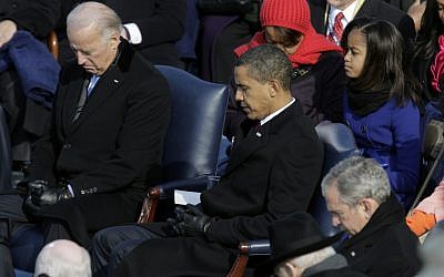Vice President-elect Joe Biden, President-elect Barack Obama and President George W. Bush, left to right, bow their heads during the invocation at the beginning of the swearing-in ceremony at the U.S. Capitol in Washington, Tuesday, Jan. 20, 2009 (photo credit: AP/Jae C. Hong)
