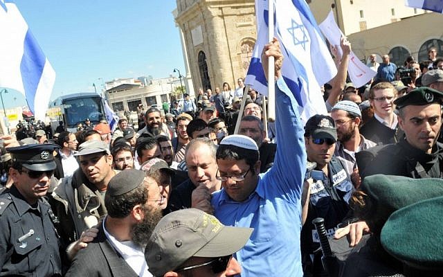 Itamar Ben Gvir, in blue, and Baruch Marzel, with beard, marching through Jaffa in 2011. (photo credit: Yossi Zeliger/Flash90)