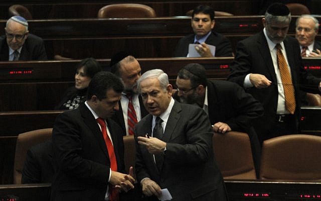 Prime Minister Benjamin Netanyahu speaks with Likud MK Carmel Shama HaCohen at the Knesset (photo credit: Miriam Alster/Flash90)