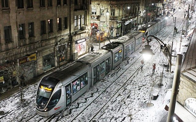 The Jerusalem Light Rail on a snow covered Jaffa Road on Wednesday (photo credit: Miriam Alster/Flash90)