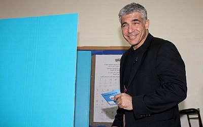 Yair Lapid, head of the Yesh Atid party, casts his vote in a polling station in Tel Aviv, January 22, 2013. (Photo credit: Gideon Markowicz/Flash90)