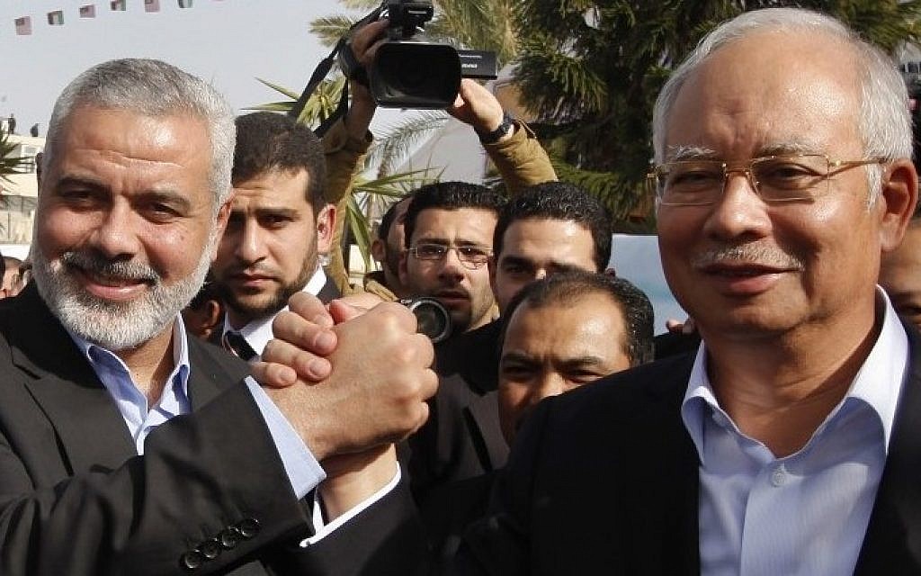 Gaza's former Hamas prime minister Ismail Haniyeh, left, greets Malaysian Prime Minister Najib Razak, right, after his arrival in Gaza City on Tuesday, January 22, 2013. (photo credit: AP Photo/ Mohammed Salem, Pool)