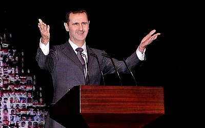 In this photo released by the Syrian official news agency SANA, Syrian President Bashar Assad gestures as he speaks at the Opera House in central Damascus, Syria, Sunday, Jan. 6, 2013 (Photo credit: AP/SANA)