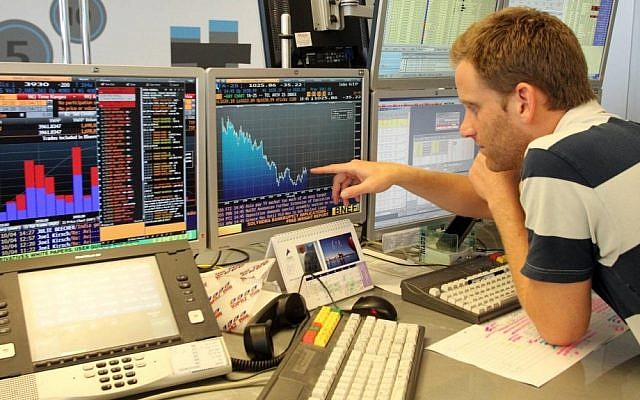 An analyst checks the numbers on the Tel Aviv Stock Exchange (Photo credit Meir Partush/Flash90)
