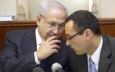 Prime Minister Benjamin Netanyahu, left, speaks with Cabinet Secretary Zvi Hauser at a weekly cabinet meeting in July 2009. (photo credit: Ariel Jerozolimski/Flash90/File)