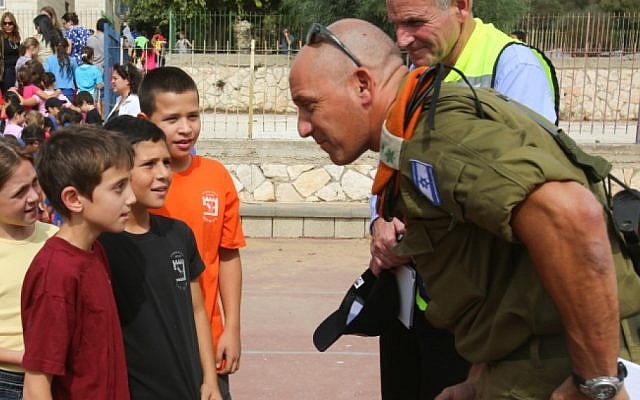 An officer from the Home Front Command talks to students during an emergency drill at an Israeli school, October 2012 (photo credit: Oren Nahshon/Flash90)