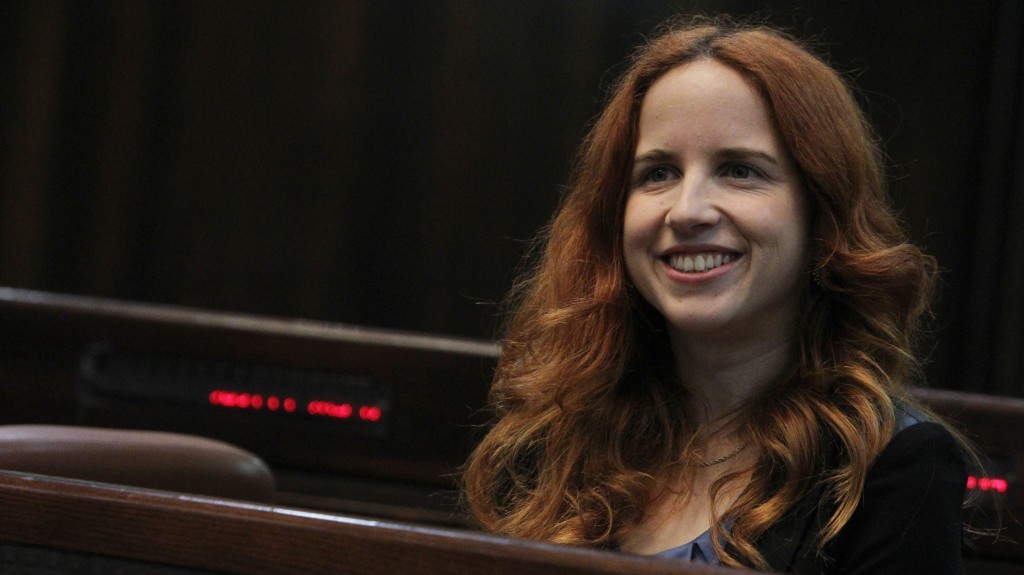 Incoming Knesset member Stav Shaffir of the Labor Party tries out her chair in the plenum, Sunday (photo credit: Miriam Alster/Flash90)