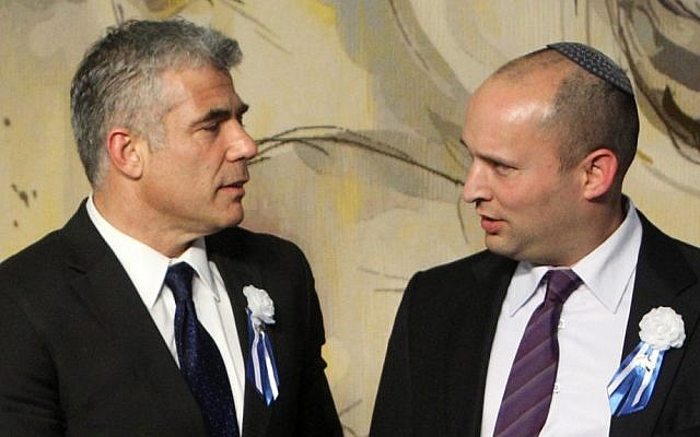 Finance Minister Yair Lapid, left, and Economy Minister Naftali Bennett at the opening session of the Knesset in January, 2013. (Miriam Alster/Flash90)