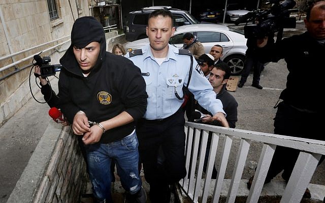 Police bring two suspects arrested for arson at the Beitar Jerusalem football team's office to the Magistrate's Court in Jerusalem on February 19, 2013. (photo credit: Miriam Alster/Flash90)