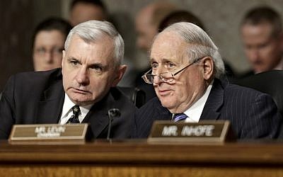 Senate Armed Services Committee Chairman Sen. Carl Levin, D-Mich., right, talks with committee member Sen. Jack Reed, D-R.I., during the committee's confirmation hearing for former Nebraska Republican Sen. Chuck Hagel, President Obama's choice for defense secretary, on Capitol Hill on January 31. (photo credit: AP Photo/J. Scott Applewhite)