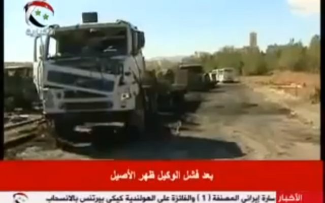 A burnt out truck seen in a video from Syrian state TV purporting to show damage caused by an Israeli strike on a research facility. (via YouTube)