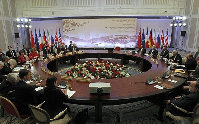 Diplomats participate in the fourth round of high-level talks with an Iranian delegation, right, aimed at stopping the Islamic regime's nuclear program from making atomic weapons in Almaty, Kazakhstan in February. (photo credit: AP/ Shamil Zhumatov, Pool)