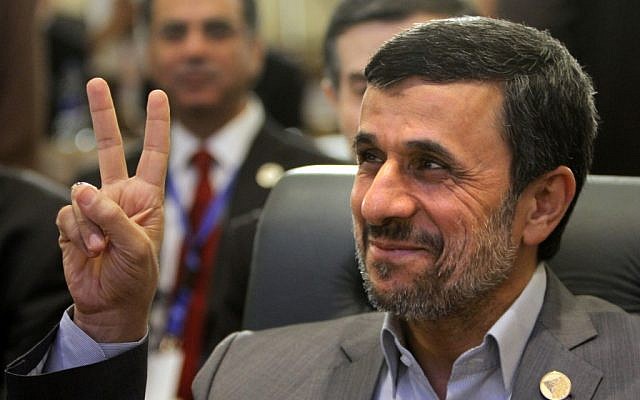 Iran's President Mahmoud Ahmadinejad flashes the victory sign as he attends the 12th summit of the Organization of Islamic Cooperation in Cairo, Egypt, Wednesday, Feb. 6 (Photo credit: AP/Amr Nabil)
