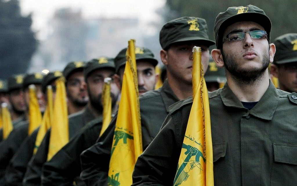 Hezbollah fighters hold party flags during a parade in a southern suburb of Beirut, Lebanon (AP/Hussein Malla/File)