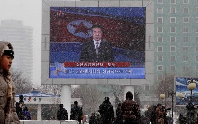 On a large television screen in front of Pyongyang's railway station, a North Korean state television broadcaster announces the news that North Korea conducted a nuclear test on Tuesday, Feb. 12, 2013. (photo credit: AP/Kim Kwang Hyon)