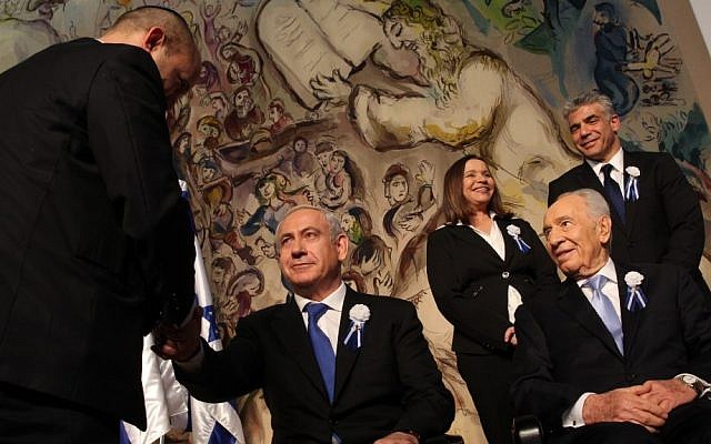 Prime Minister Benjamin Netanyahu, center, shakes hands with Jewish Home leader Naftali Bennett at the opening session of the Knesset earlier this month, as President Shimon Peres looks on. Behind them are Labor's Shelly Yachimovich and Yesh Atid's Yair Lapid. (Photo credit: Nati Shohat/Flash90)