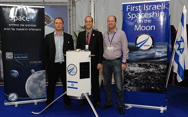 Three of SpaceIL's founders -- Yariv Bash, Yonatan Winetraub, and Kfir Damari -- with a model of the spacecraft they propose to send to the moon (photo credit: Alon Hadar)