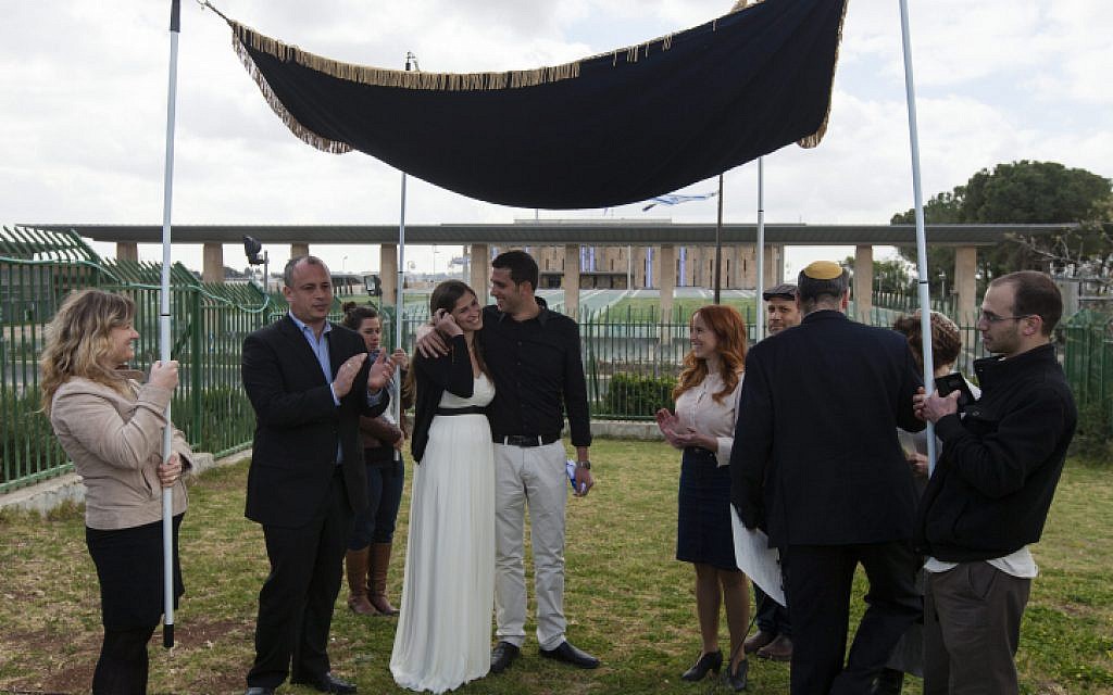 MK Stav Shaffir (to the right of wedding couple) participates in a Reform Jewish wedding ceremony in front of the Knesset, in protest of the Orthodox rabbinate's monopoly on marriage licensing and the lack of civil marriage in Israel. (Flash90)