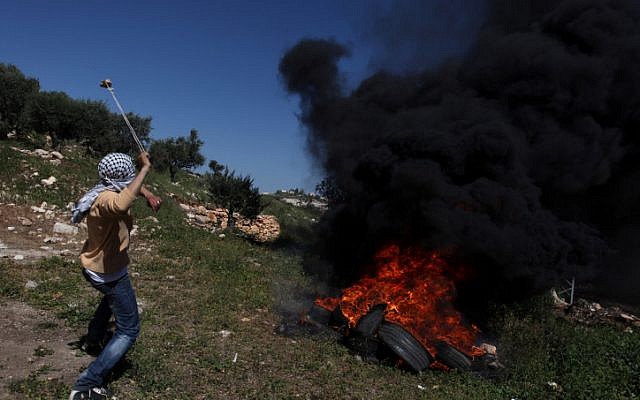 Palestinian protesters clash with Israeli soldiers near the West Bank village of Kafr Qaddum on Friday (photo credit: Issam RImawi/Flash90)