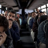 Palestinian laborers ride a bus en route to the West Bank from working in Tel Aviv area, Israel, Monday, March 4, 2013. (AP/Ariel Schalit)