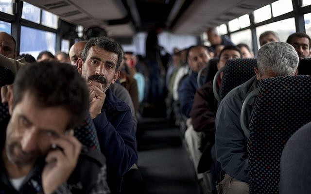 Palestinian laborers ride a bus en route to the West Bank from working in Tel Aviv area, 2013. (AP/Ariel Schalit)