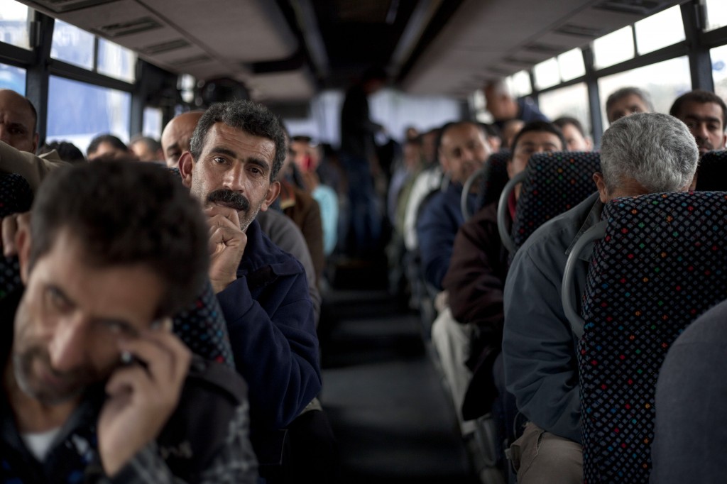 Palestinians laboPalestinian laborers ride a Palestinian-only bus en route to the West Bank from working in Tel Aviv area, Israel, Monday, March 4, 2013. (photo credit: AP/Ariel Schalitrers ride a Palestinian-only bus on route to the West Bank from working in Tel Aviv area, Israel, Monday, March 4, 2013. (photo credit: AP/Ariel Schalit)