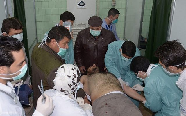 A victim of an alleged chemical weapons attack is treated by doctors in Aleppo, Syria, in March (photo credit: AP/SANA)
