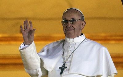 Pope Francis waves to the crowd from the central balcony of St. Peter's Basilica at the Vatican, Wednesday, March 13, 2013. Cardinal Jorge Bergoglio who chose the name of Francis is the 266th pontiff of the Roman Catholic Church (photo credit: AP/Gregorio Borgia)