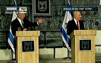 Benjamin Netanyahu, left, and Shimon Peres at the President's Residence Monday night. (Screenshot: Knesset Channel) 